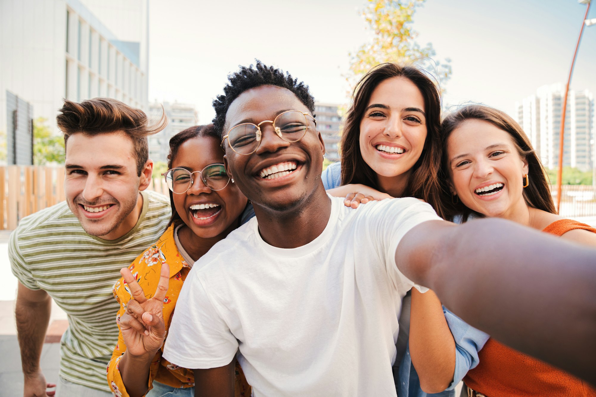 Group of multiracial young student people smiling and taking a selfie together. Close up portrait of