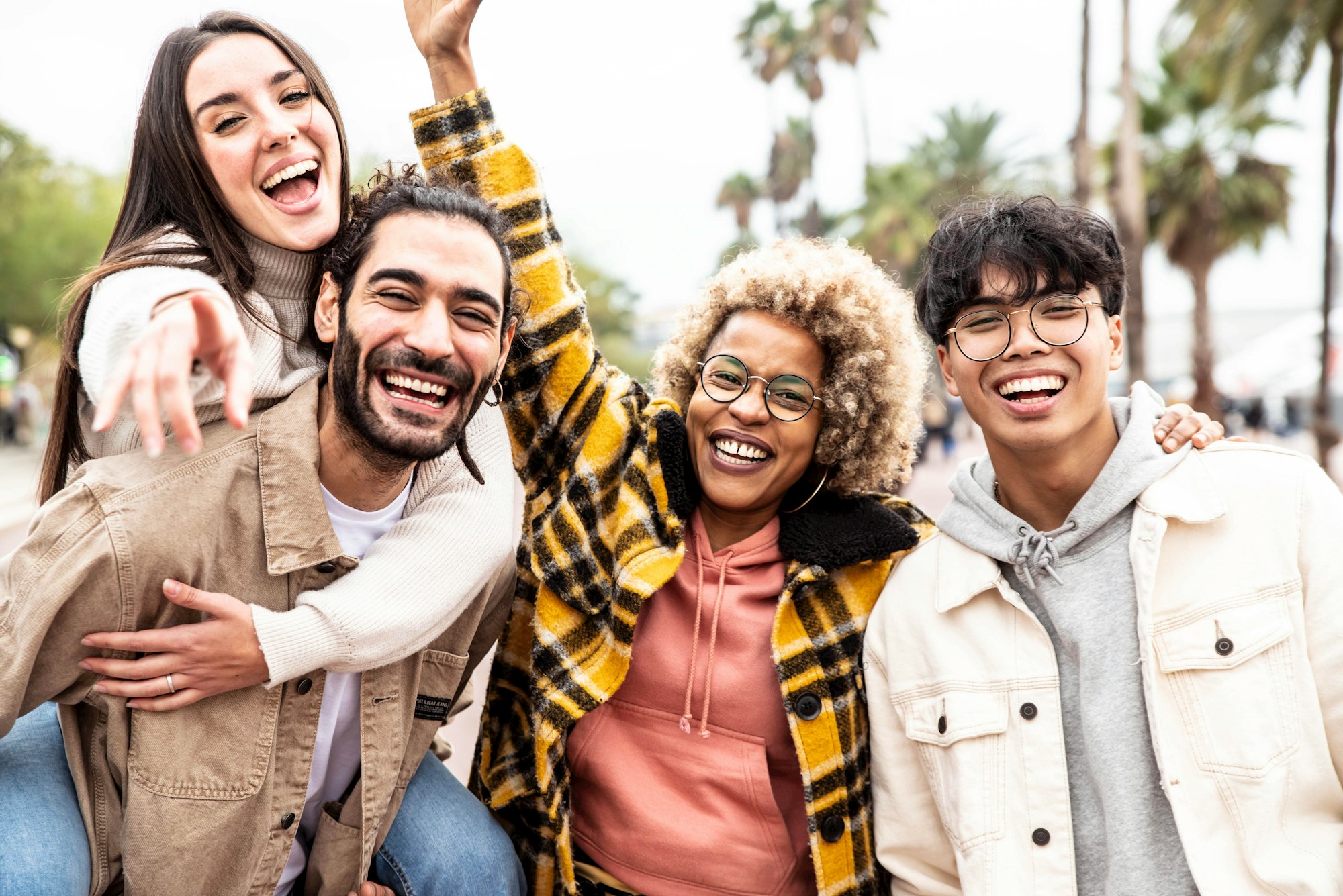 Multiracial group of young people smiling together at camera